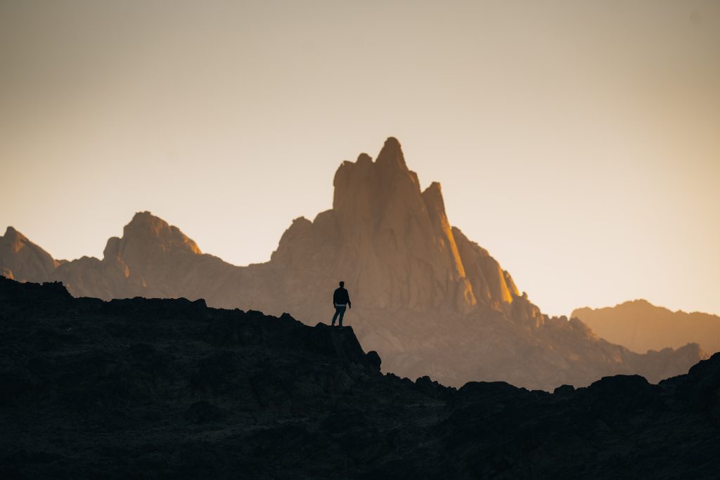 A man looking out the horizon filled with mountains